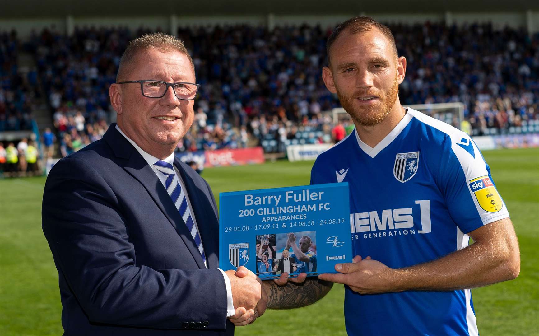 Barry Fuller is presented with a momento by chairman Paul Scally to mark his 200th appearance for Gills Picture: Ady Kerry
