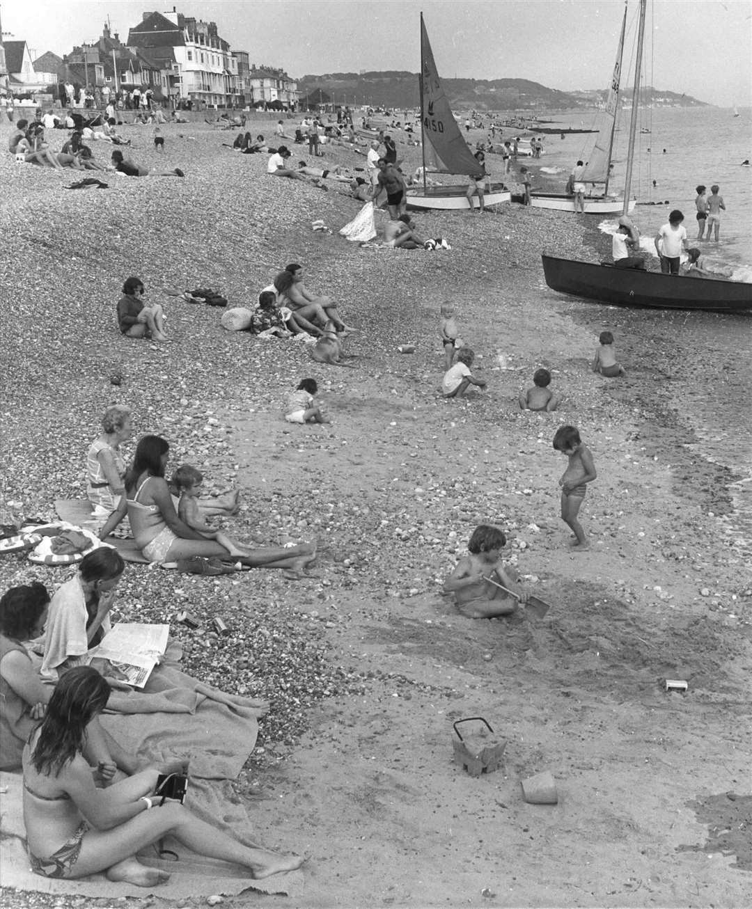 Families relaxing on Hythe beach in August 1971