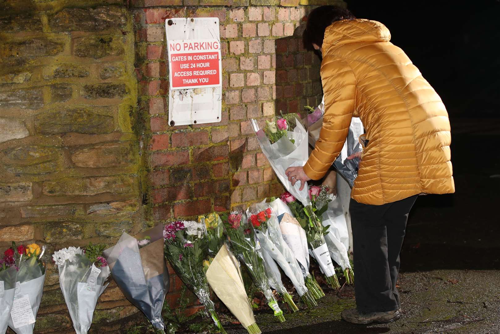 A member of the public leaves a floral tribute outside the home of Captain Sir Tom Moore (Yui Mok/PA)
