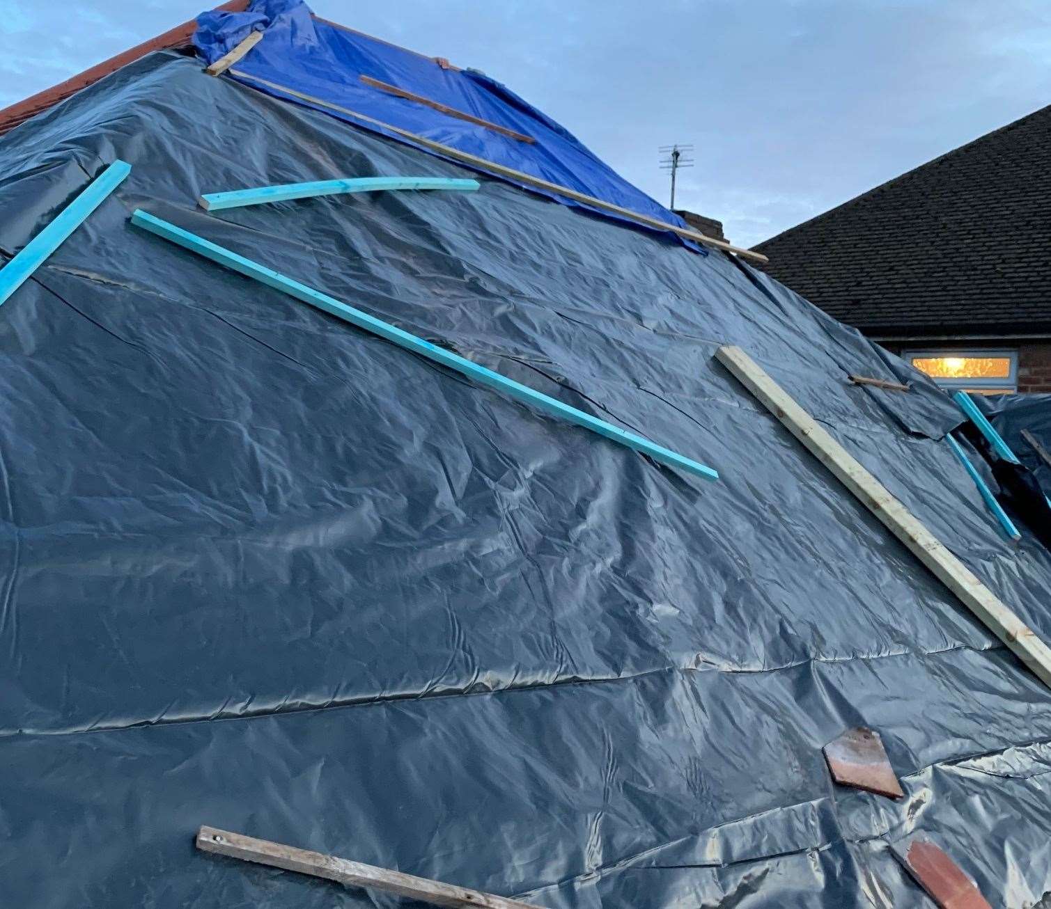 Makeshift sheeting covers up damage caused by the fraudsters