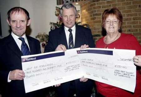 Graham East (centre) of the North Kent Sunday League presents cheques to Patrick Lindsay of Kent Air Ambulance and Joy Blunderfield of Lions Hospice