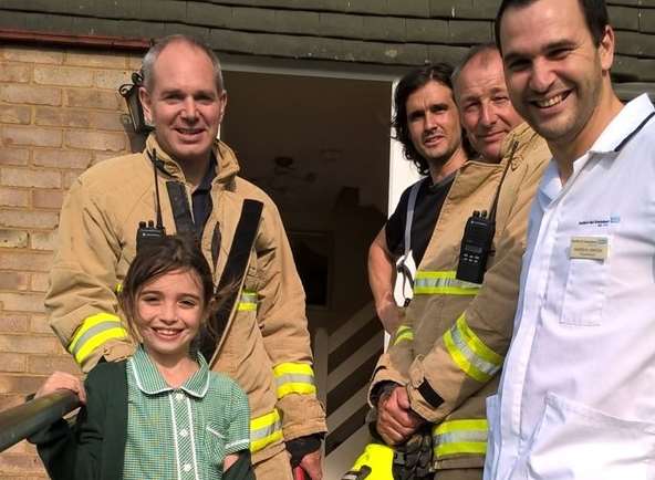 Isabelle Lowden, 7, with dad, Andy, and firefighters from Dartford fire station