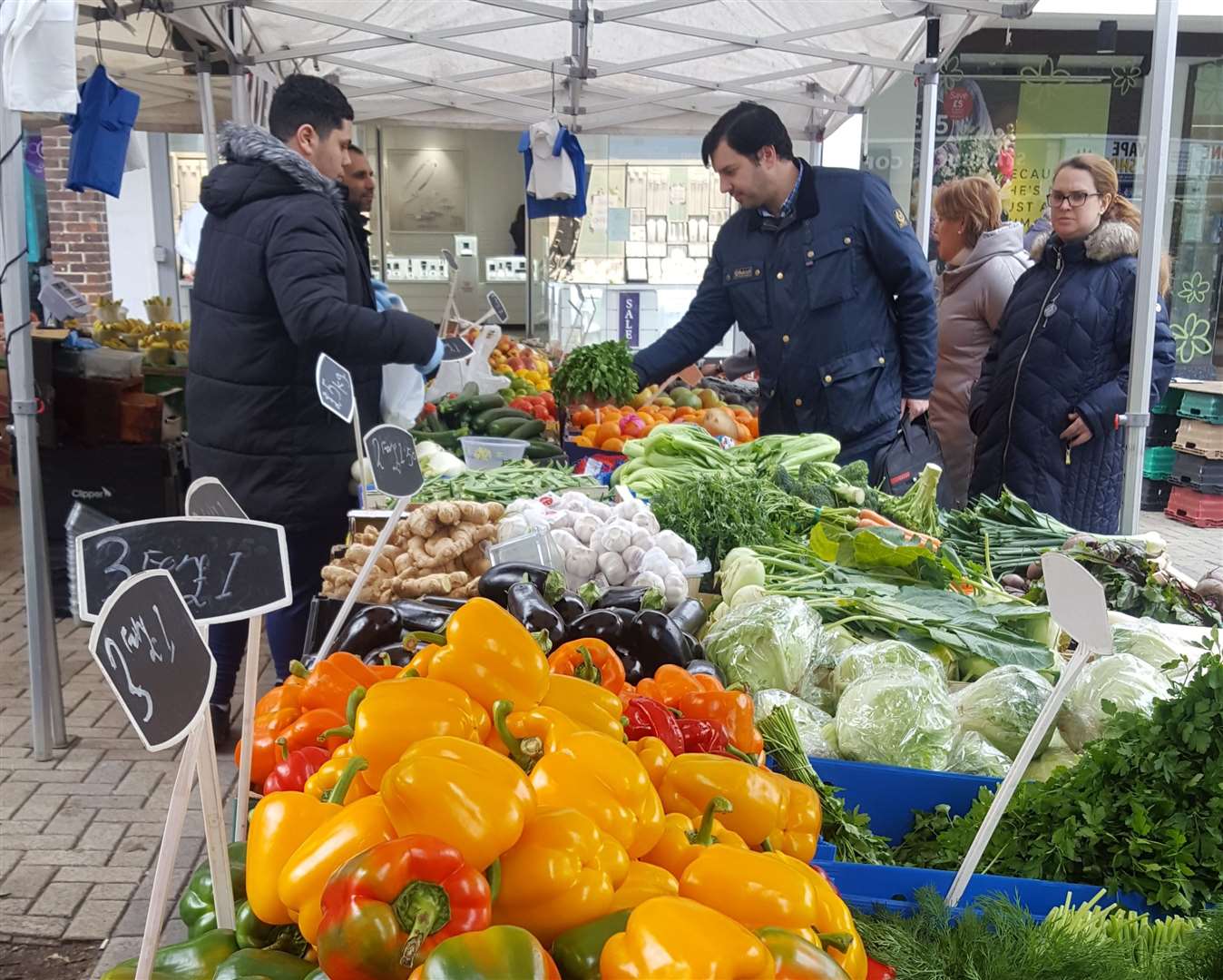 Punters buying fruit and veg at the market