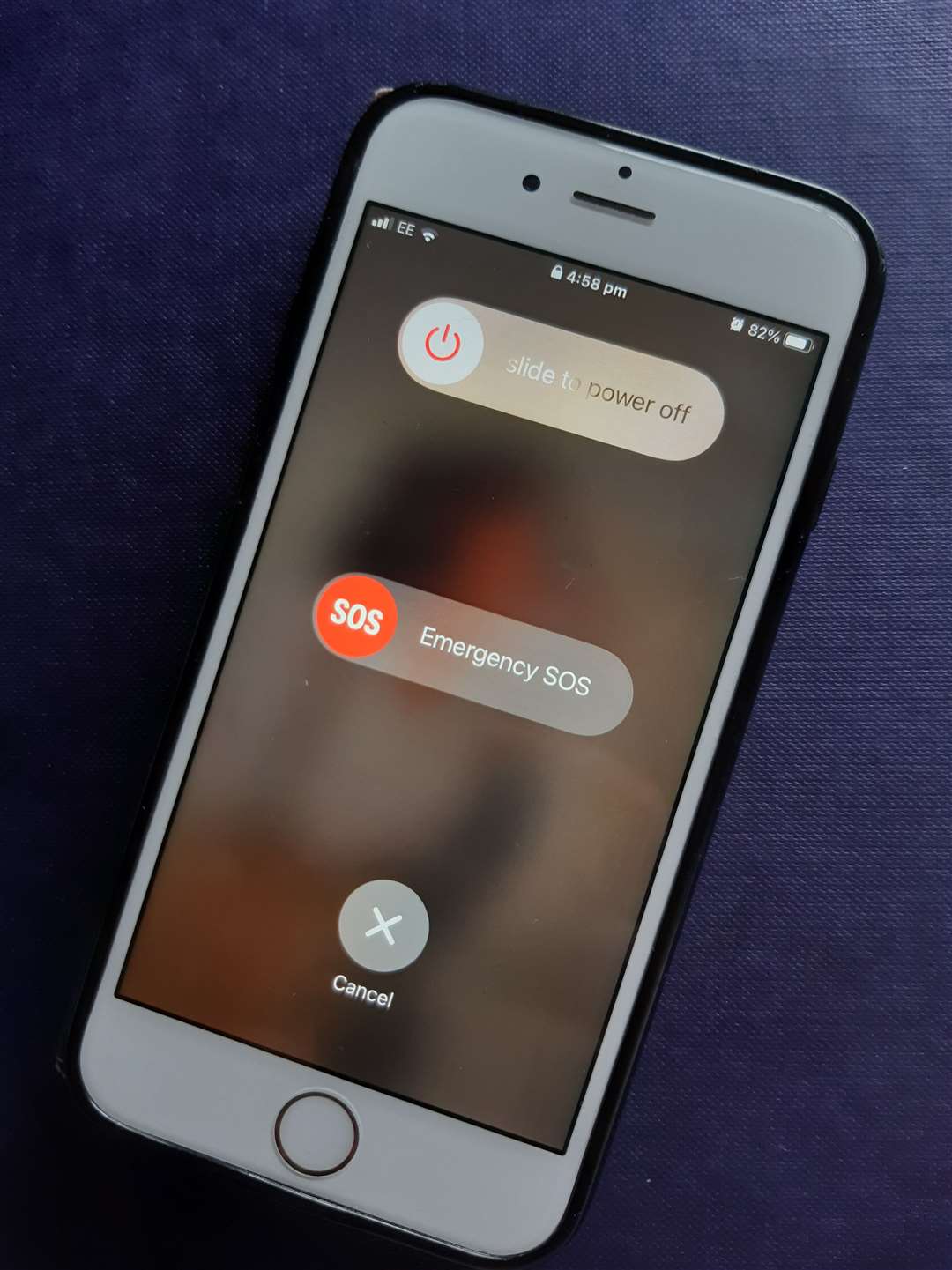 If you click the lock button on the side of your iPhone it will give you the option to discreetly call the police