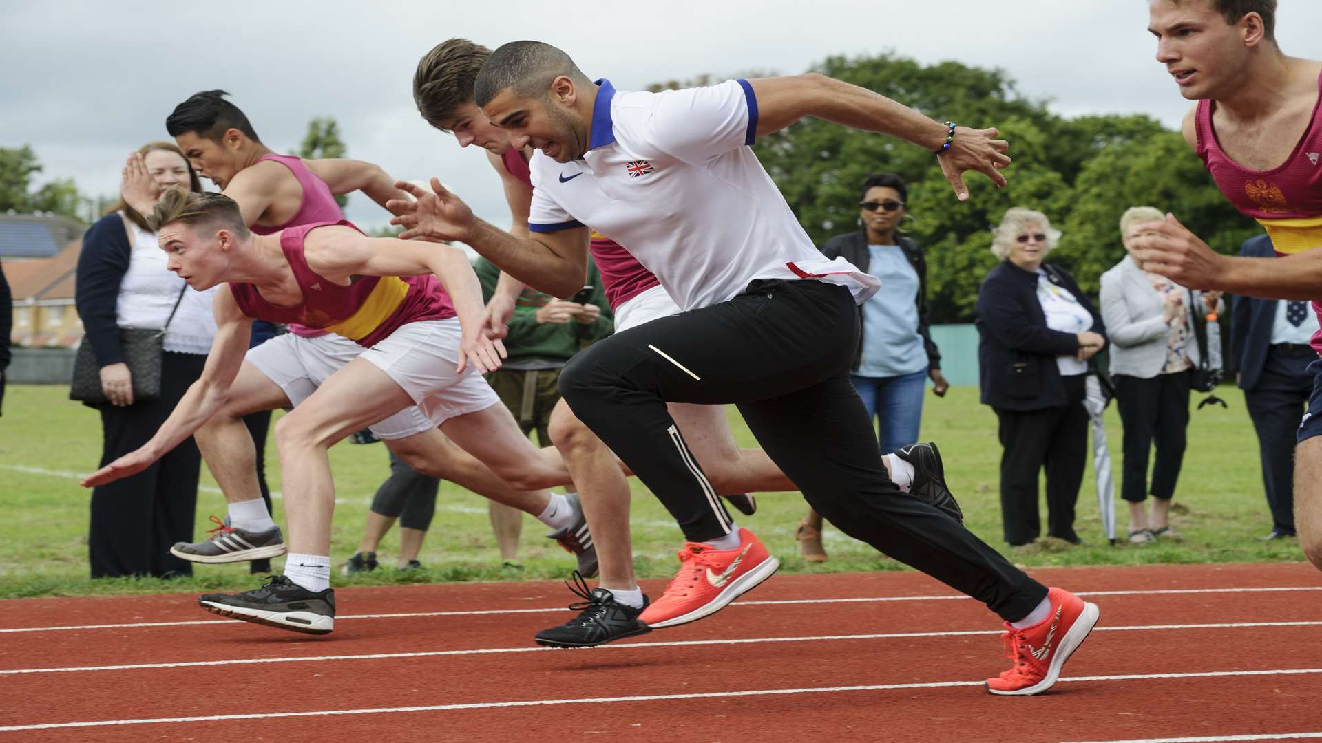 Adam Gemili races some of the Year 13 pupils on the new track