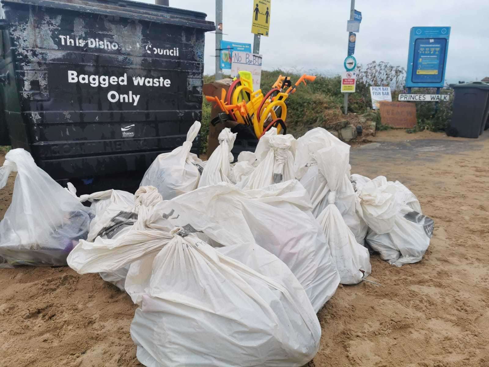 Bags of rubbish are collected from the beach