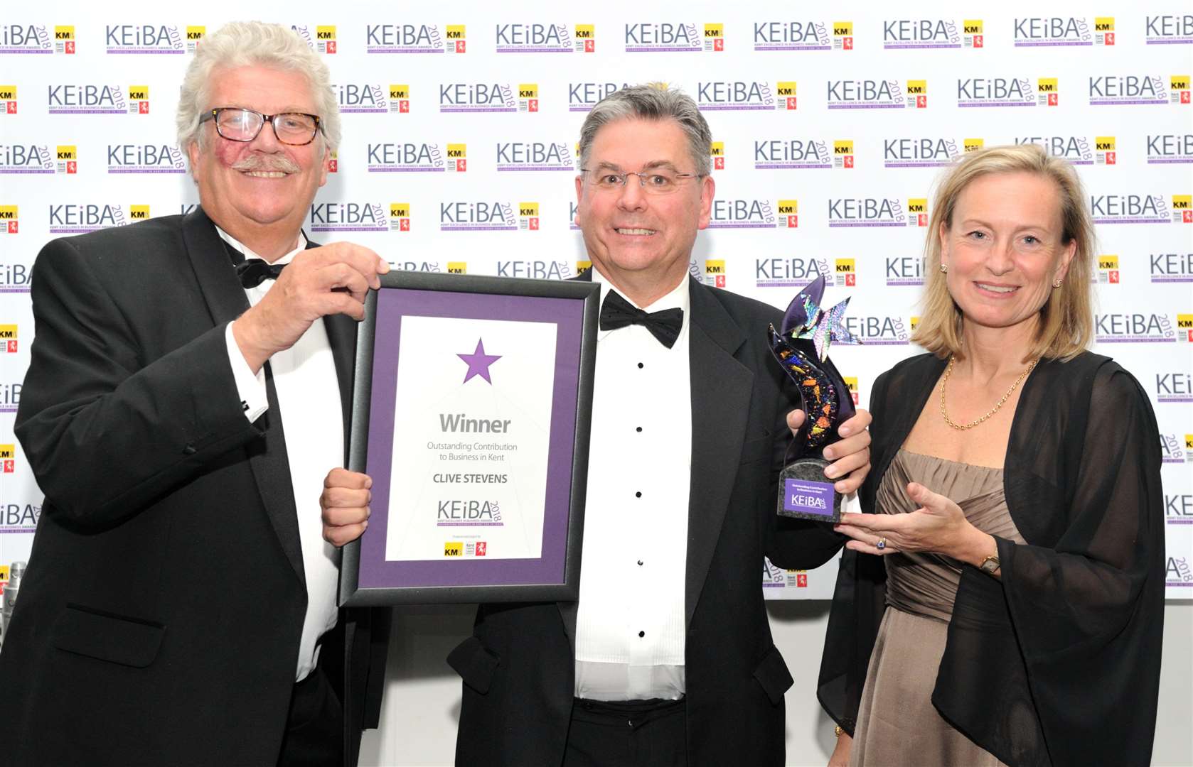 Mark Dance, left, and Geraldine Allinson present the 2018 KEiBA for Outstanding Contribution to Business to Clive Stevens of Kreston Reeves