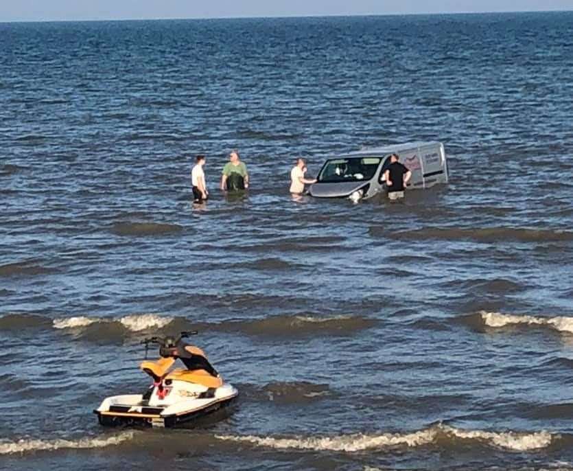 The men could be seen fighting to rescue the vehicle. Photo: Susan Pilcher