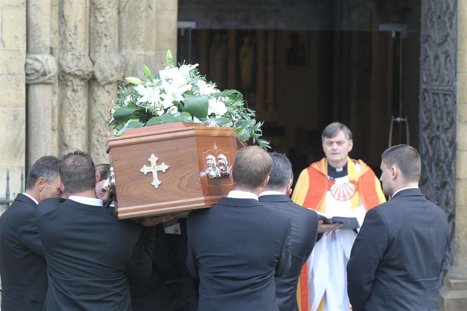 Pallbearers take the coffin of Jody Duff into Rochester Cathedral