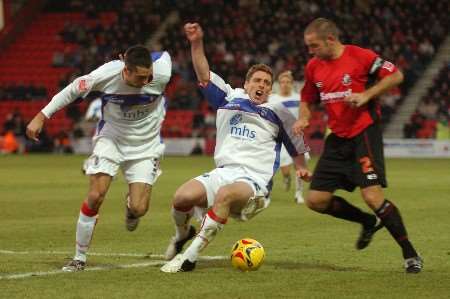 Neil Harris goes to ground after a tackle by Bournemouth captain Neil Young. Picture: BARRY GOODWIN