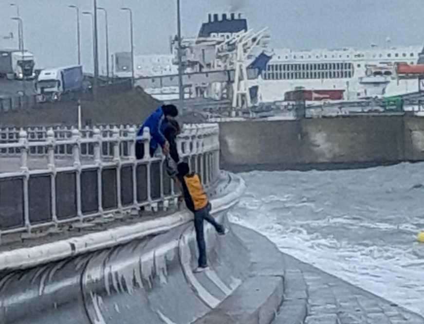 John Bain being pulled to safety by his son and friend from the raging sea during Storm Ciaran in Dover. Picture: Jemima Parker