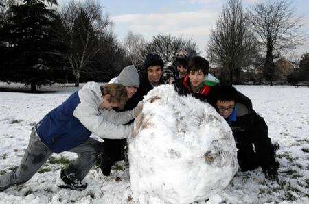 Some lads with their massive snow ball in Central Park