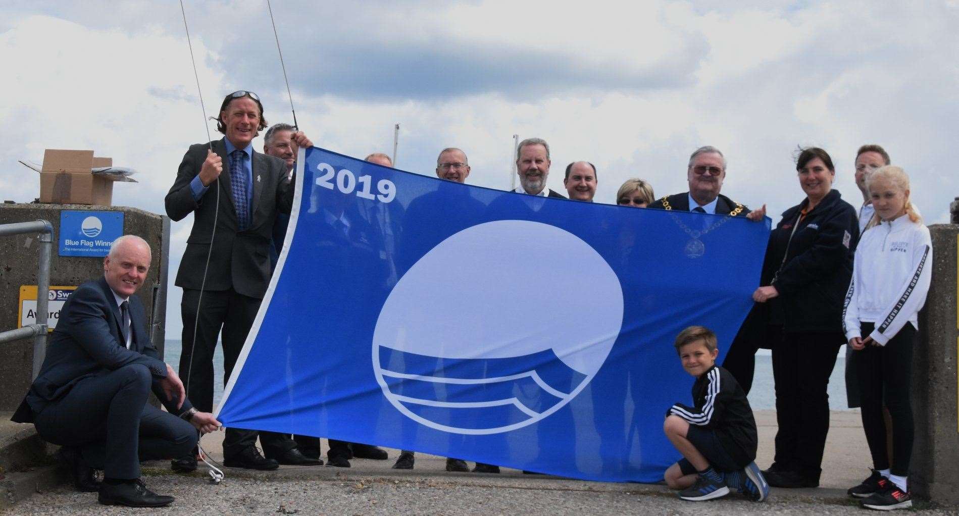 Raising the Blue Flag on Sheerness beach with Swale council's beachfront manager Ian Arnell, Mayor of Swale Cllr Ken Ingleton, Coastguards, KCC warden, Swale council's environment warden, Swale Leisure, the seafront team and Cllr James Hunt and his children. Picture: Bob Richards (11513402)