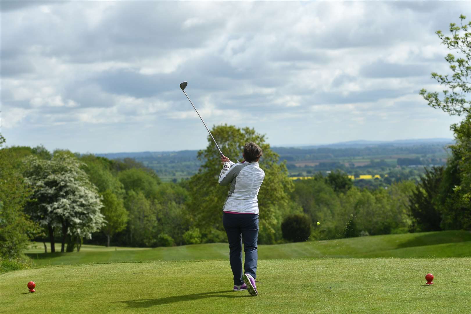 Annie Price plays the fourth hole at Llanymynech Golf Club, Oswestry, where the course crosses the border of England and Wales (Jacob King/PA)
