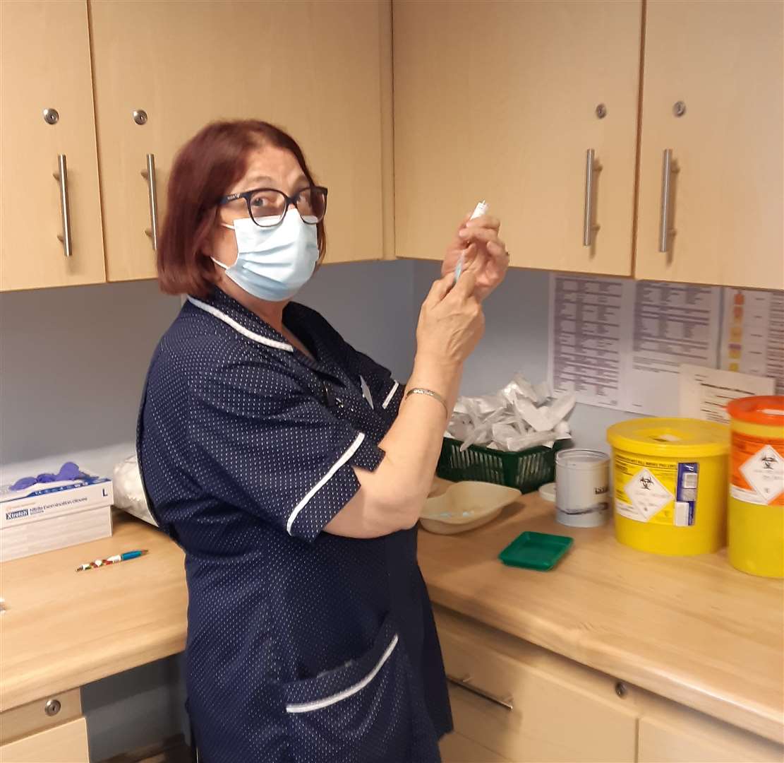 Nurse Sara Martin makes up a new batch of the vaccine to administer