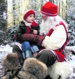 Father Christmas and young visitor at Lapland UK