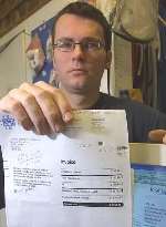 FACING RUIN: Lee Smith with his phone bill for a massive £5,700. Picture: JOHN WESTHROP