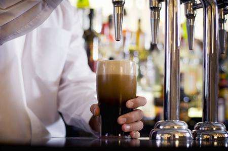 Barman pulling a pint in a pub. Stock picture