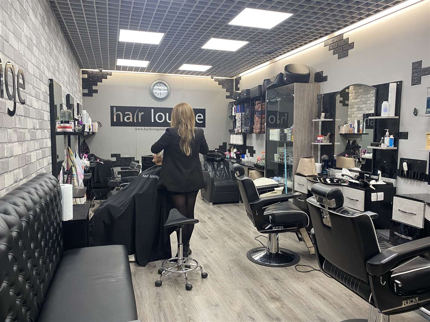 The day before restrictions lifted, staff at the Hair Lounge were not wearing masks