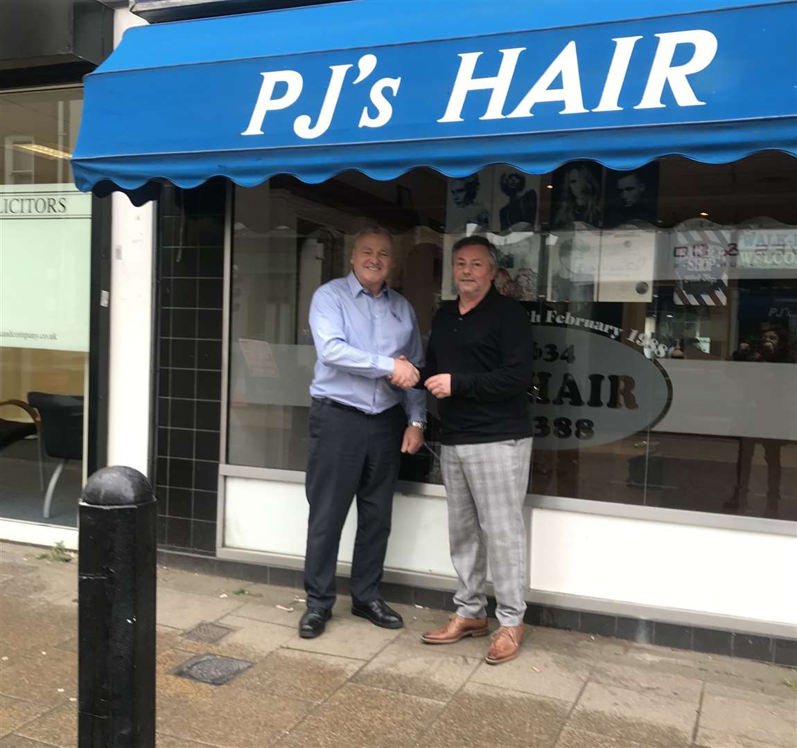Hairdresser Pieri Mazzone, right and his first customer 35 years ago Mick Kiernan who returned for a trim this week.