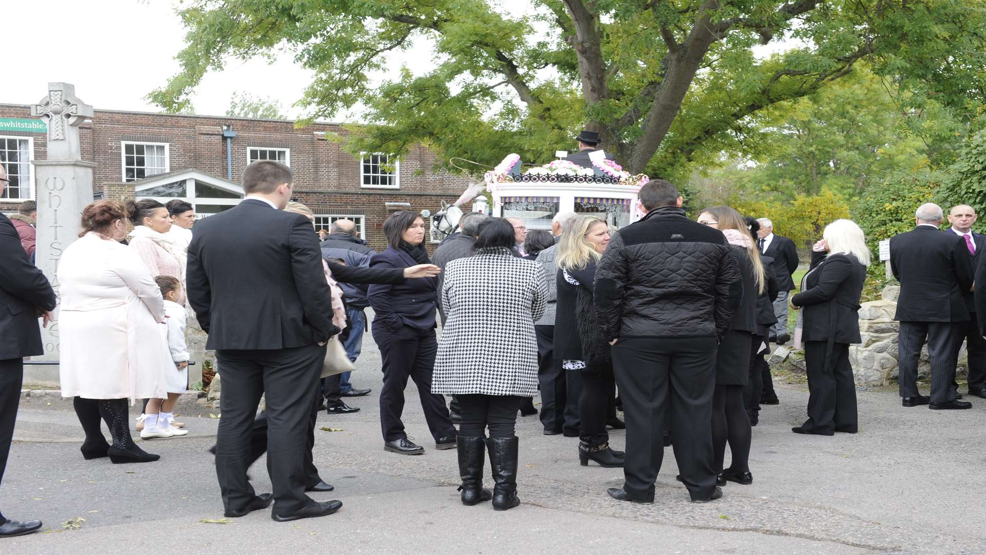 Mourners gather outside the church