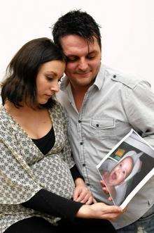 Lucy-Rae and Mark-Antony with a picture of Xara-Mae