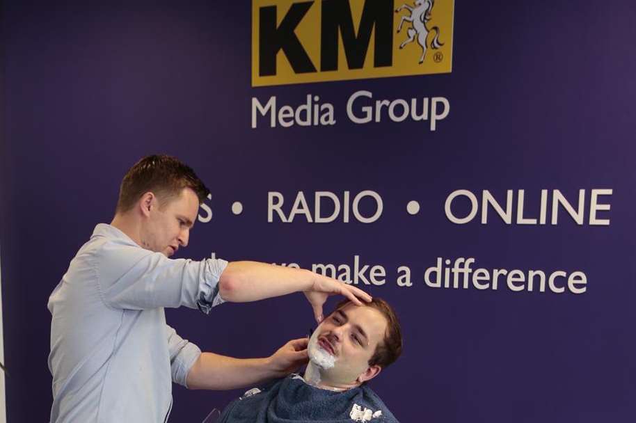 KM reporter Ed McConnell getting a full shave from mobile barber Darryl Lawson of Barbers2U