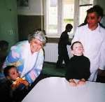 Bunny Kimbell with some of the handicapped children and a nurse at the hospice in Romania