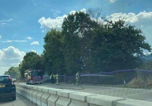 Firefighters tackle a fire on the verge by the M20 near Ashford