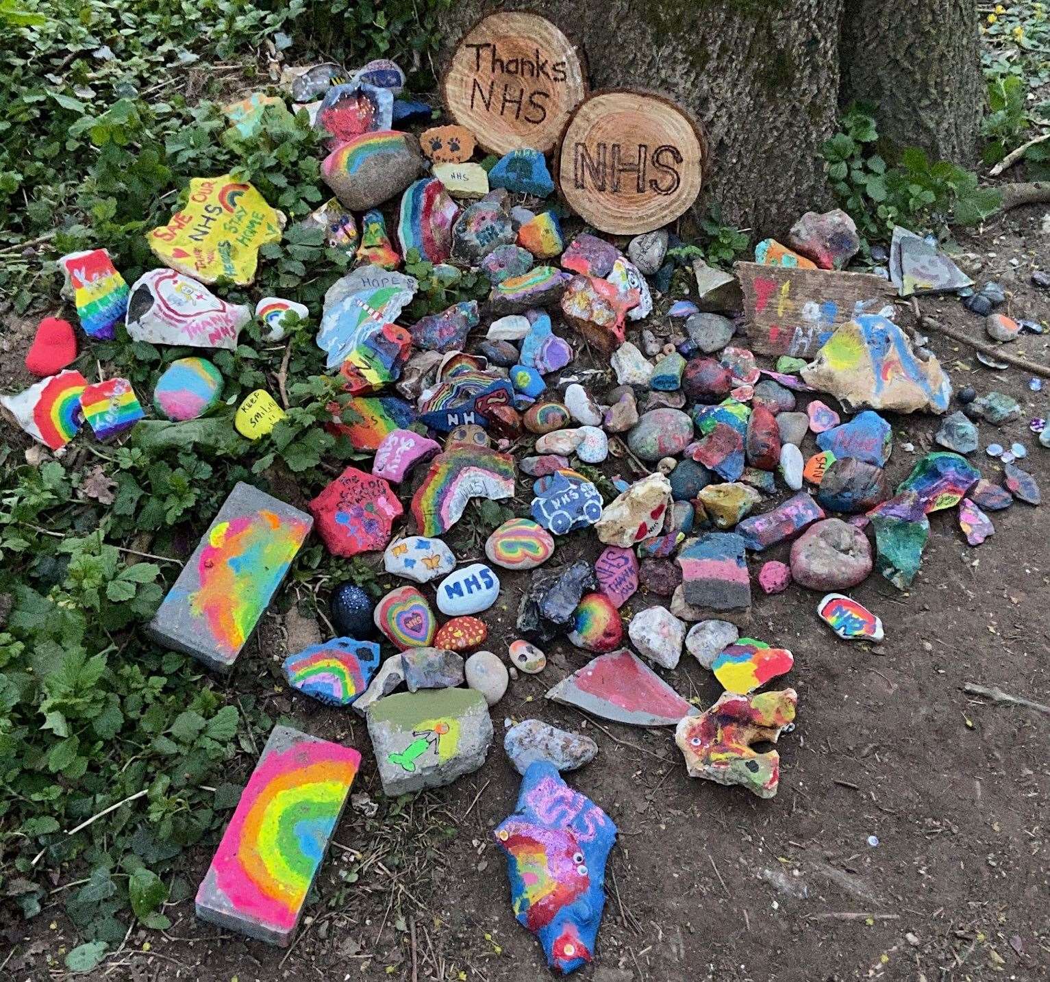 The painted pebbles supporting the NHS by Logan's tree in Taddington Wood, Chatham