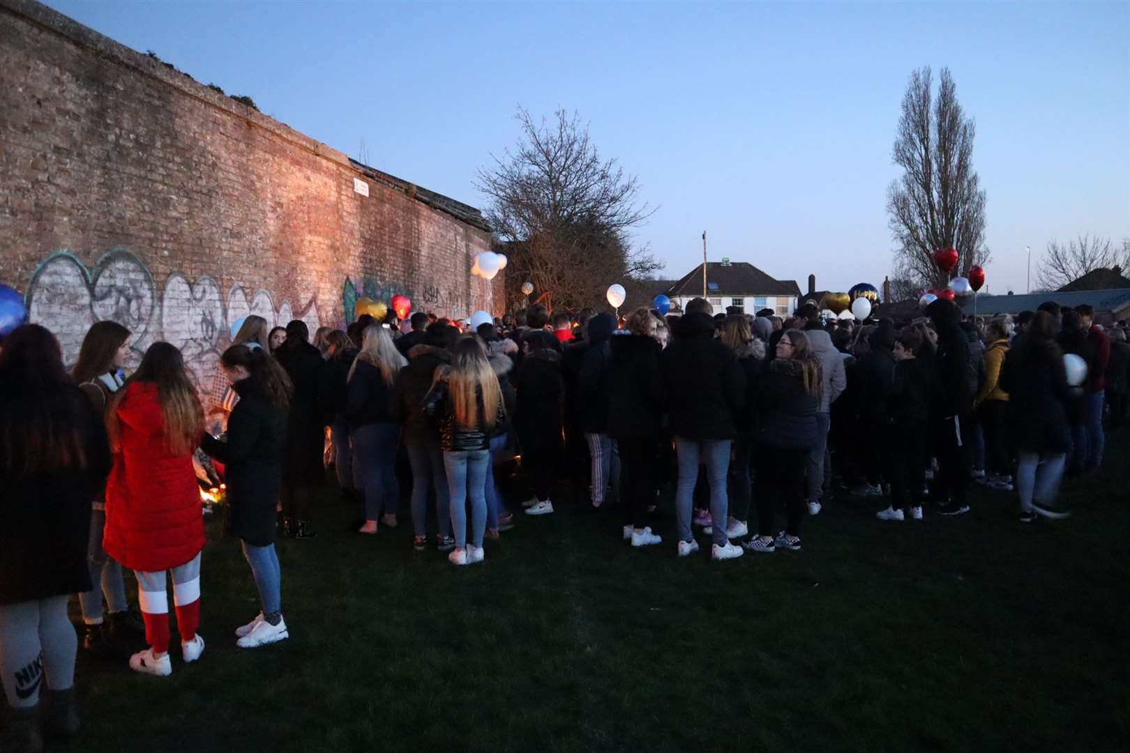 Friends gather at the candlelit vigil for Emre Huseyin in New Road playing fields, Sheerness, on Thursday
