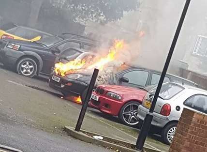 The black Ford Focus on fire in Folkestone. Picture uploaded to Shepway Watch