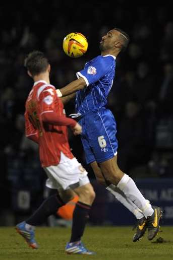 Leon Legge looks to clear the danger against Walsall. Picture: Barry Goodwin