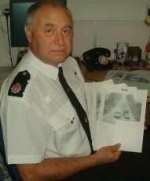 PC Dick Denyer with stills from CCTV cameras installed along Iwade's Old Ferry Road