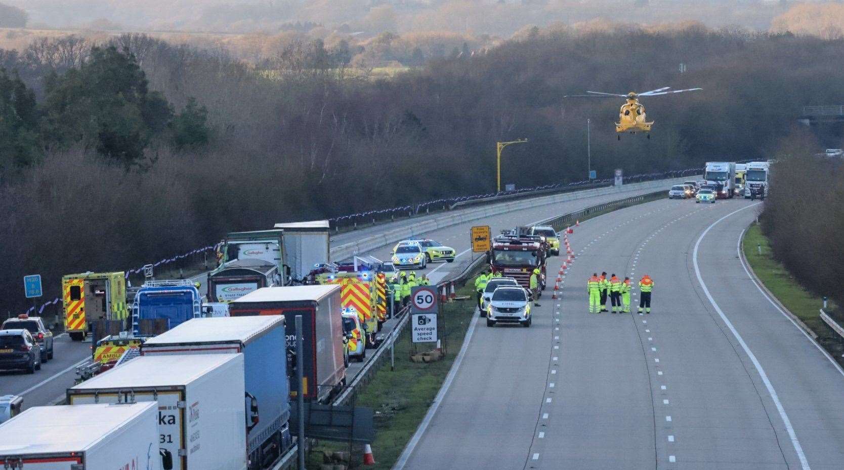 Helicopter hovers over the M20 after a serious crash between junctions 9 (Ashford) and 8 (Maidstone). Picture: UKNIP (61875888)