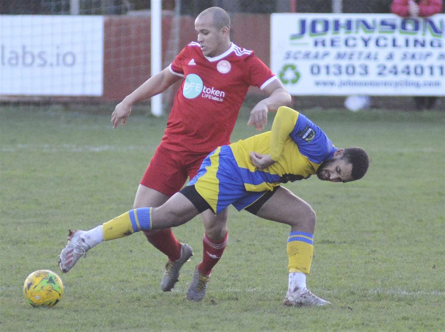 Hythe defender Tom Wynter keeps Sittingbourne's Johan Caney-Bryan at bay Picture: Paul Amos