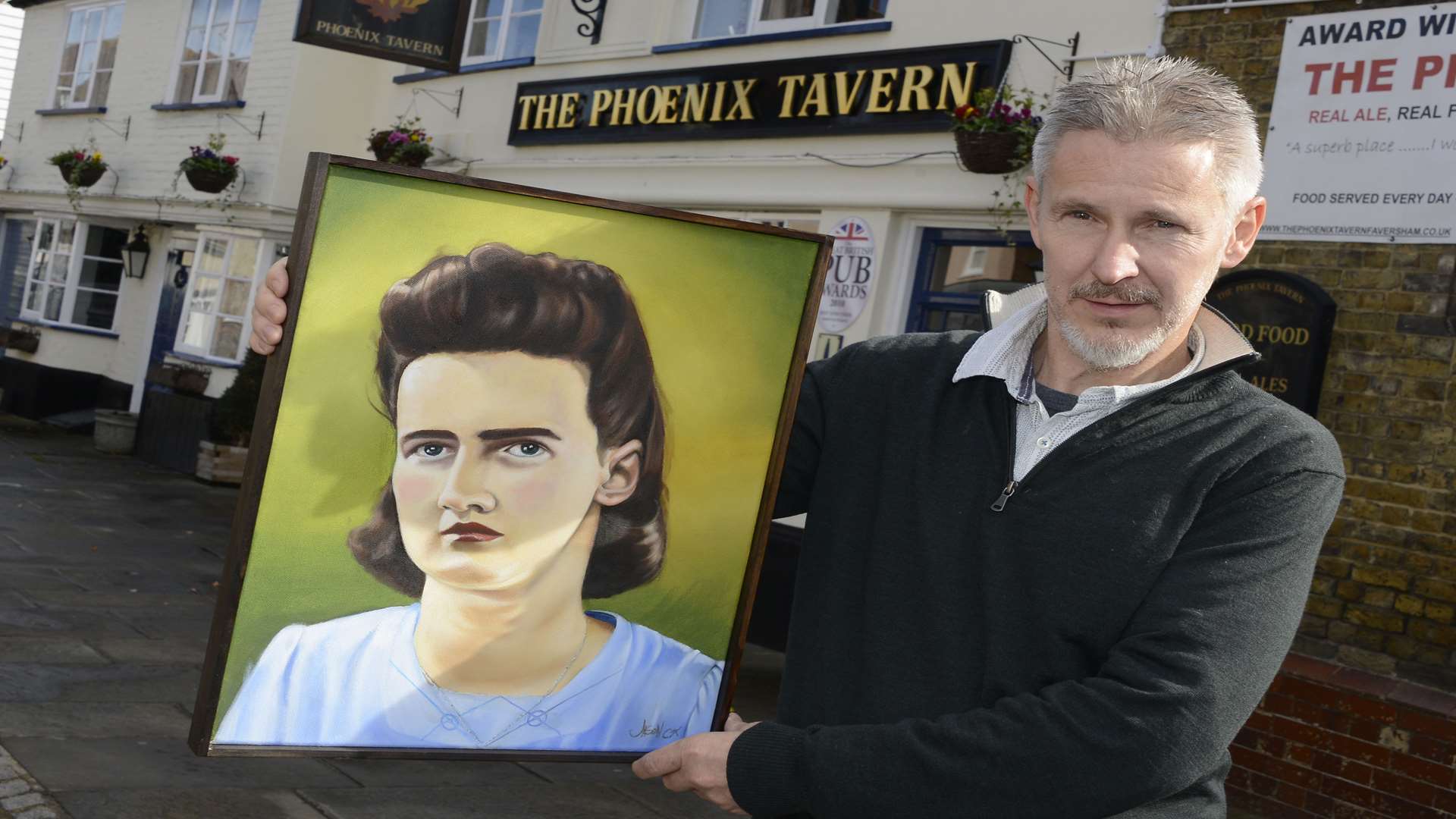Jason Cox with his oil painting of the old photograph.