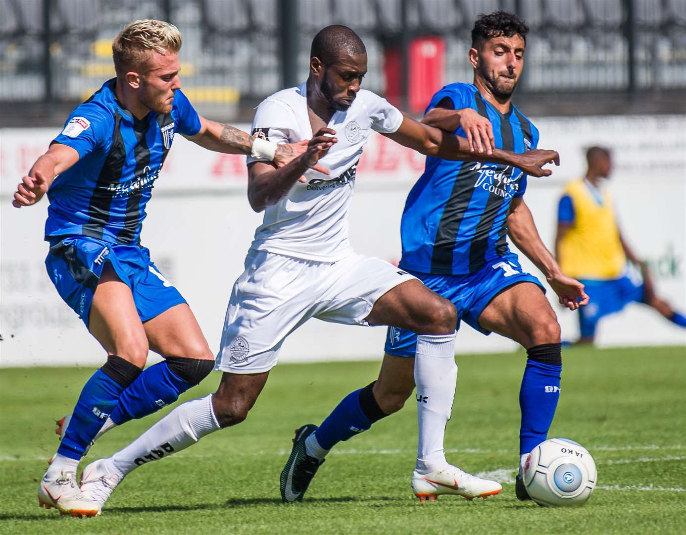 Bedsente Gomis, centre, in action for Dover against Gillingham in a pre-season game last year Picture: Alan Langley.