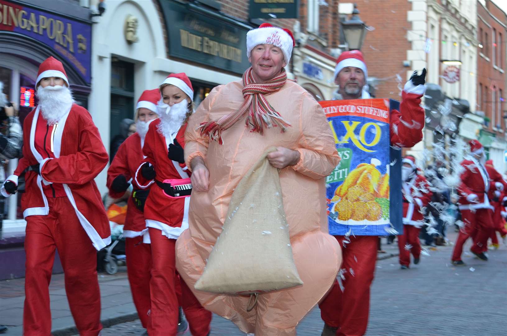 Winging it! A man dressed as a Christmas turkey runs through Rochester during the Santa run [credit: Jason Arthur]