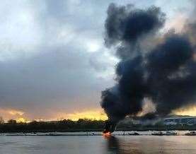 A boat fire in the River Medway, Strood, the opposite side of the astronaut. Picture: Rob Martin