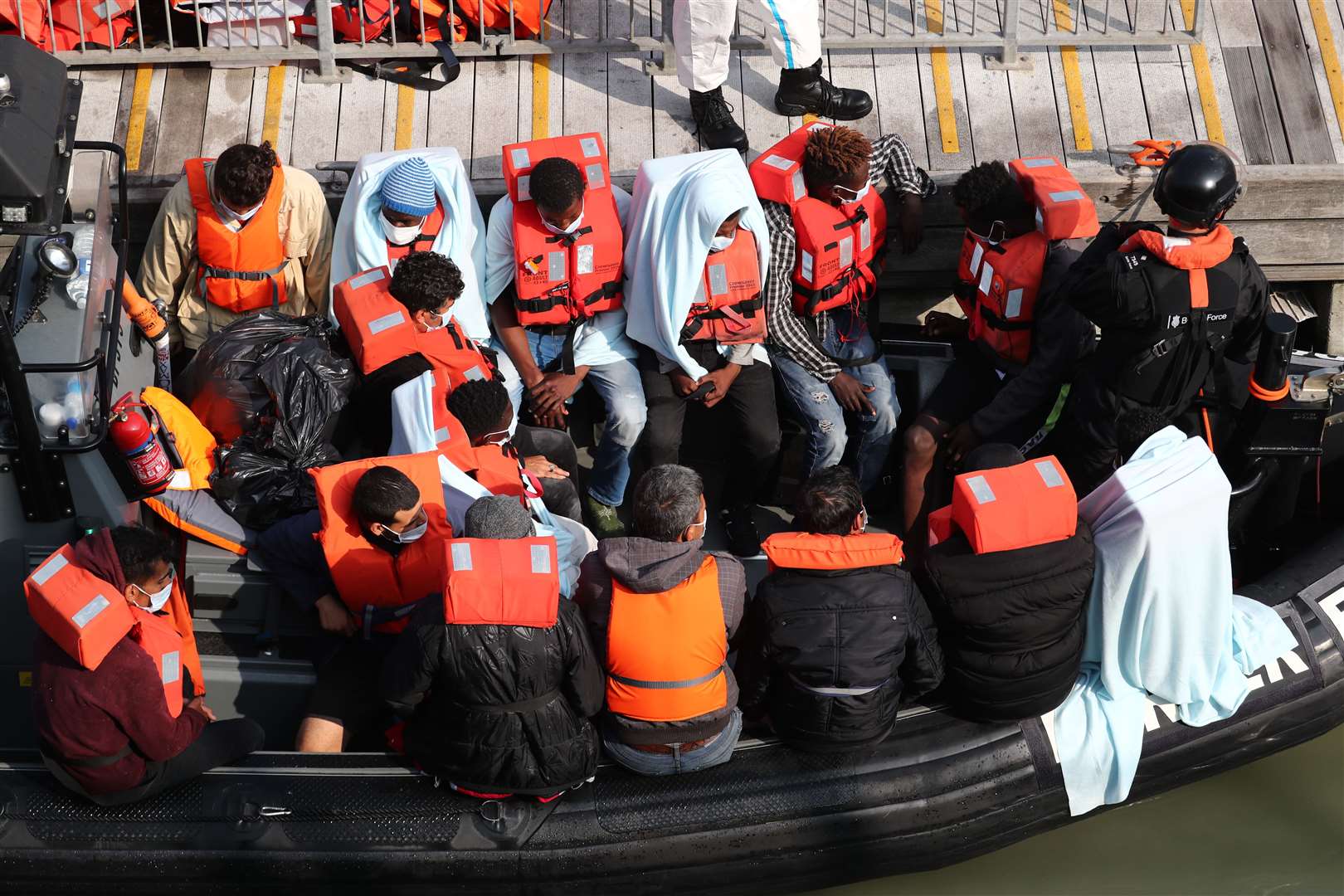 A group of people, thought to be migrants, waiting on a Border Force rib (Gareth Fuller/PA)