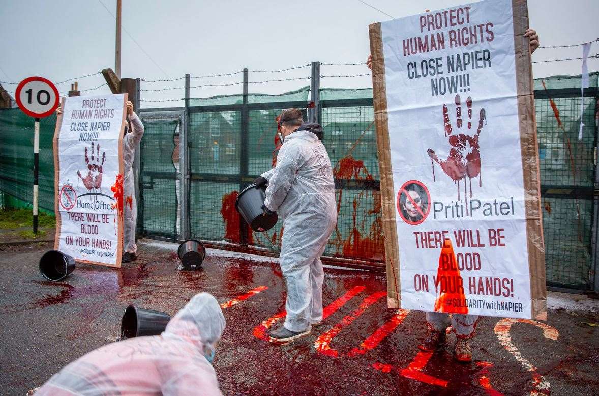 Pictures taken by Mr Aitchison show activists dressed in white suits and masks throwing buckets of fake blood. Picture: Andrew Aitchison / In pictures via Getty Images