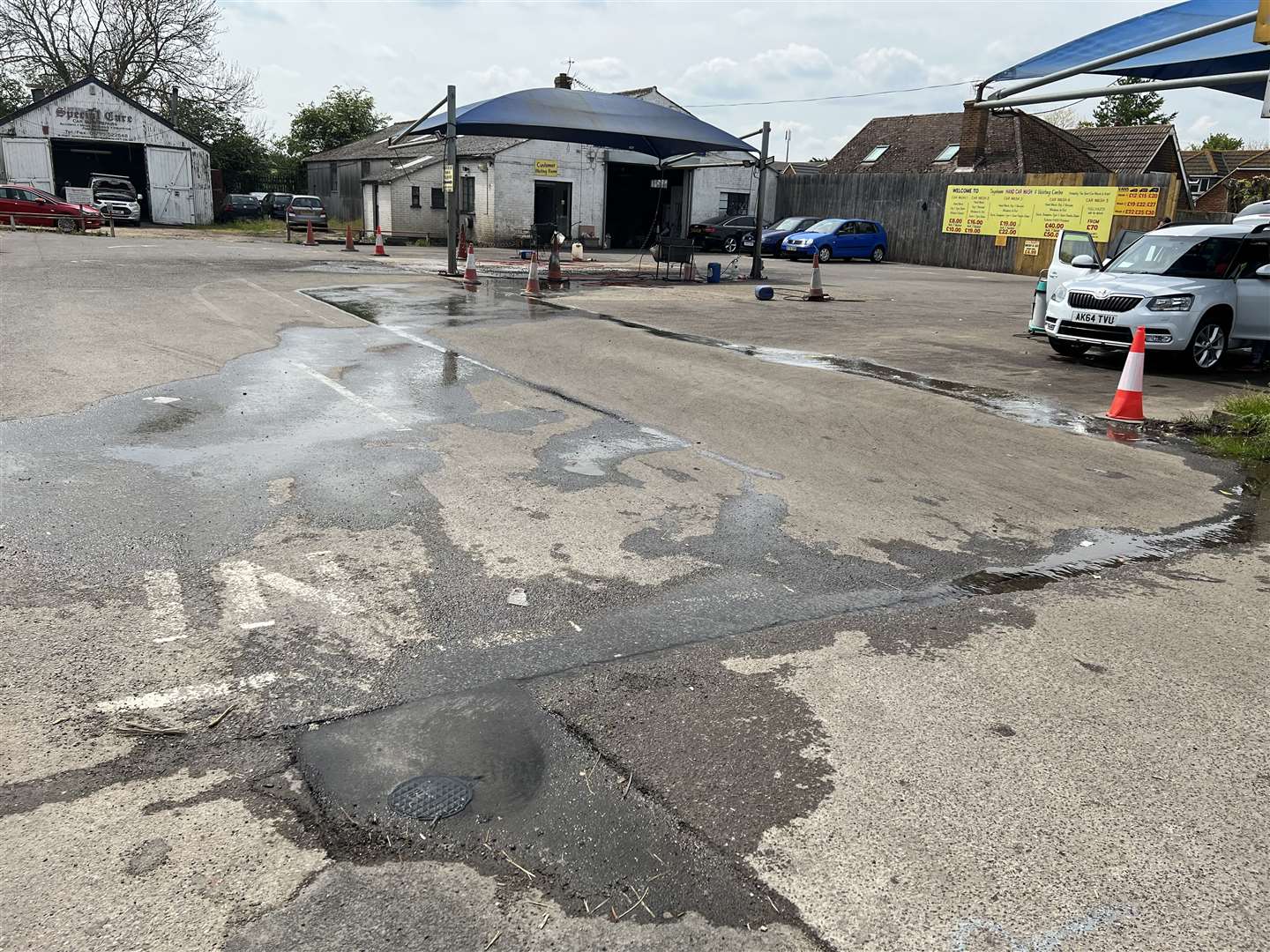 The leaking access cover outside Teynham Hand Car Wash is causing problems for the business