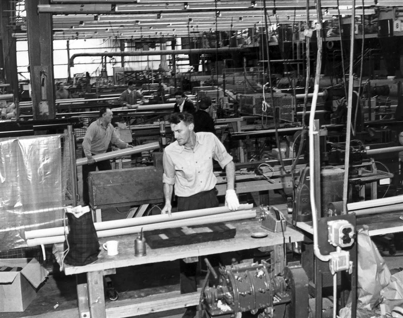 Workers producing lengths of gullies and drainpipes at Marley Tile Co. Ltd. in Harrietsham in November 1966