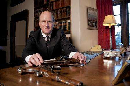 Randolph Churchill with a pair of duelling pistols belonging to Churchill’s 17th century ancestor John, 1st Duke of Marlborough, builder of Blenheim Palace at the In the Blood exhibition at Churchill's former home, Chartwell