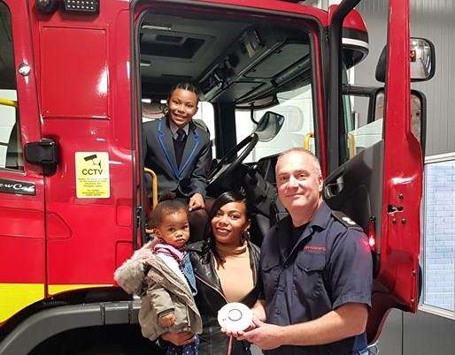 Mikayla Tenyue and her family with Rochester fire station leader Paul Nash