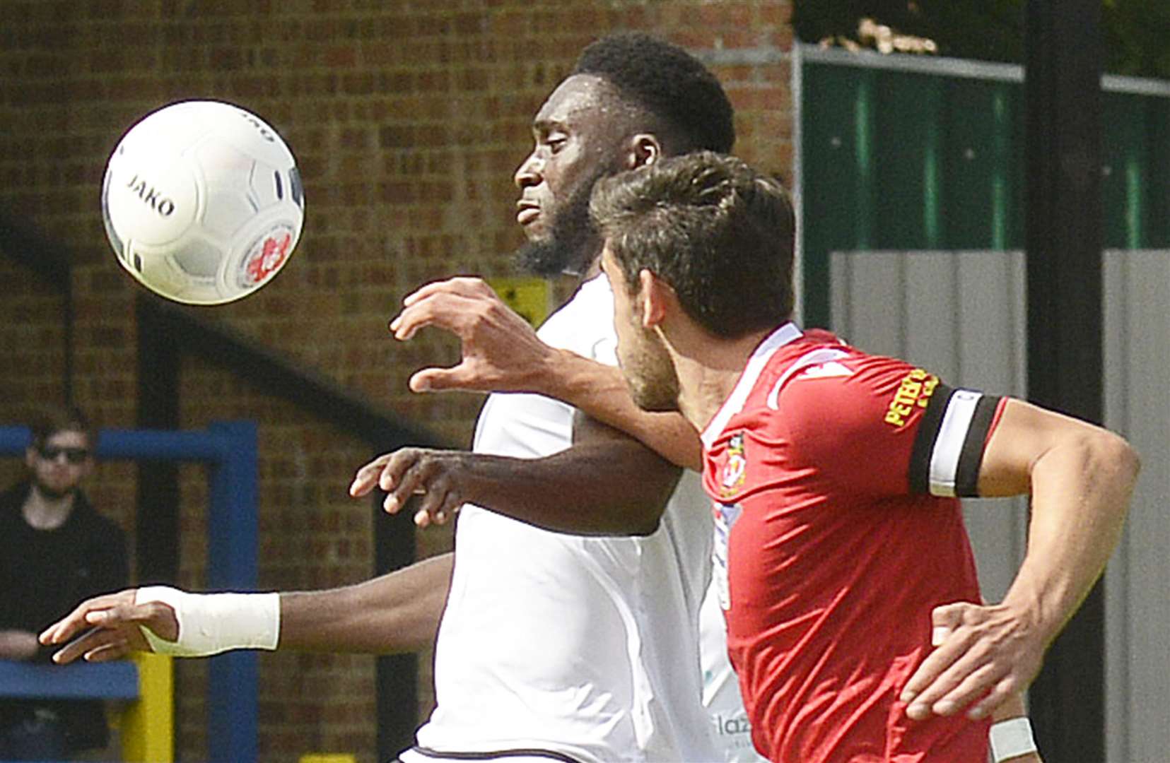 Dover's Inih Effiong holds off Wrexham captain Shaun Pearson. Picture: Paul Amos