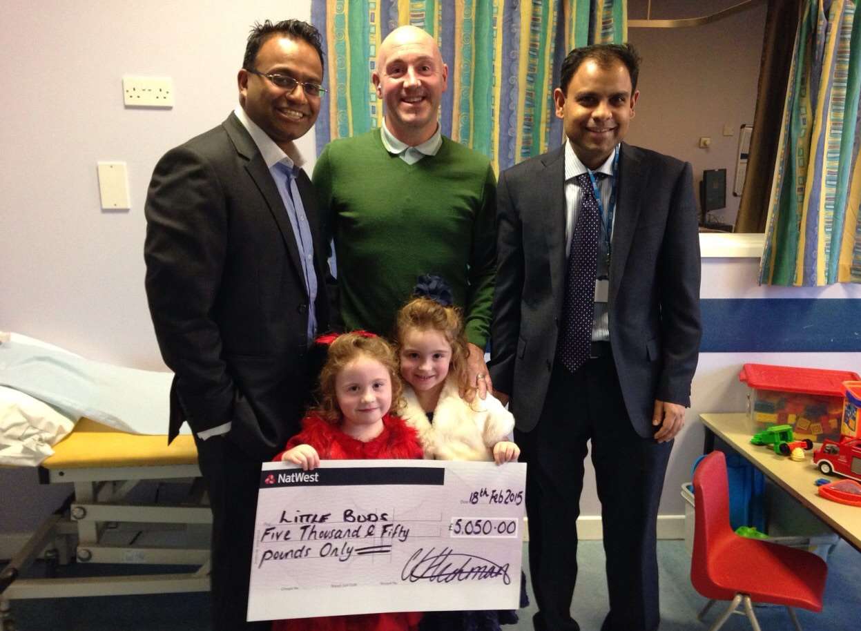 Jocey and Ellissia holding a cheque for £5,050 for the paediatric ward at Darent Valley Hospital, with Dr Shahinul Kulkarni (left) and Dr Kamran Khan