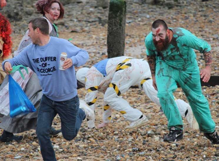'Zombies' chase people during a zombie event along the beach in Sheerness, in October 2015