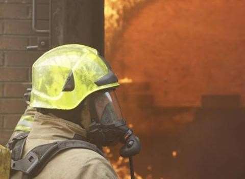 Crews wore breathing apparatus to fight the fire. Stock image.